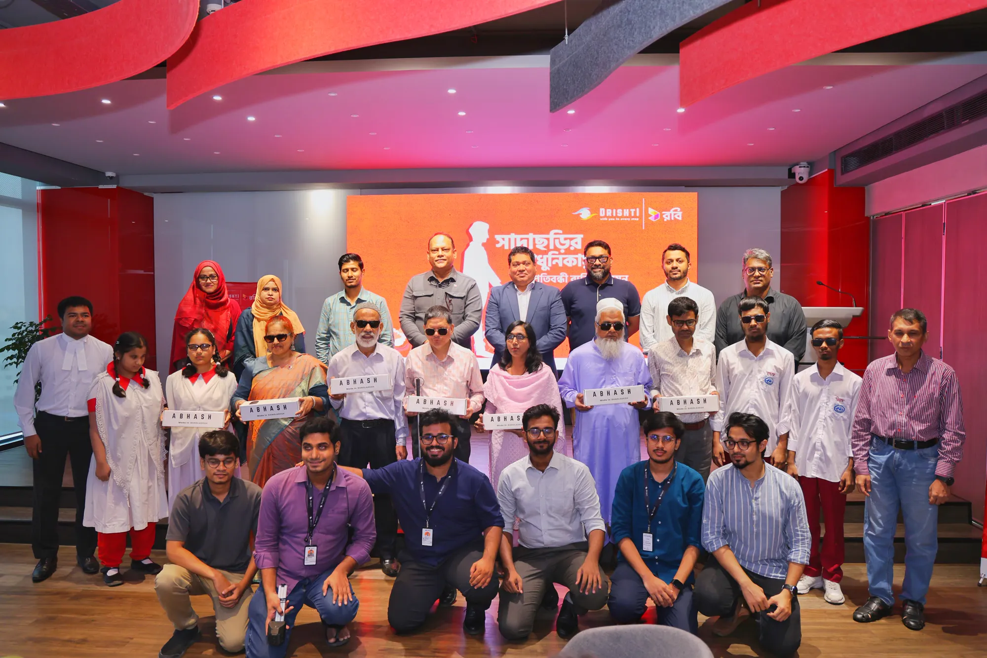 Visually impaired users holding their Abhash boxes with the Drishti team and guests at the launch event